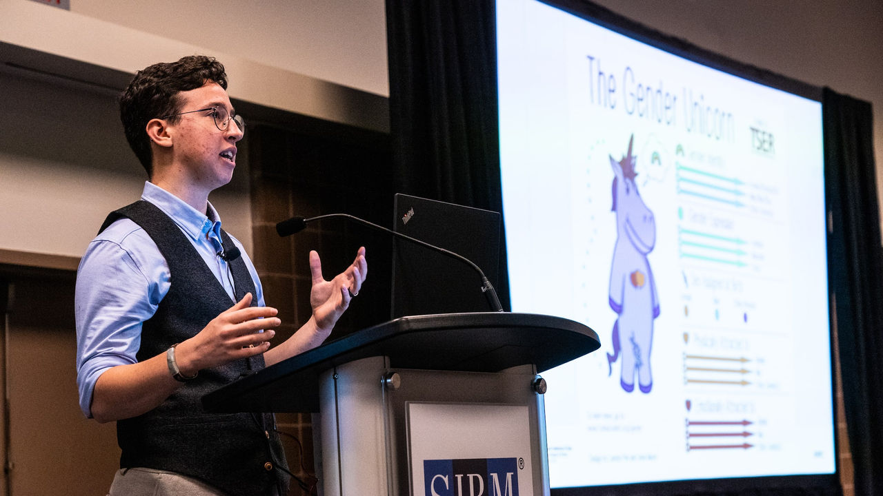A man giving a presentation at a conference.