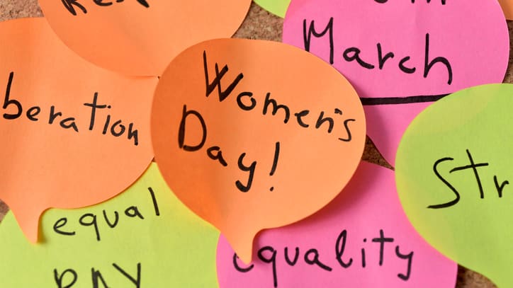 A group of colored paper with the words women's day written on it.