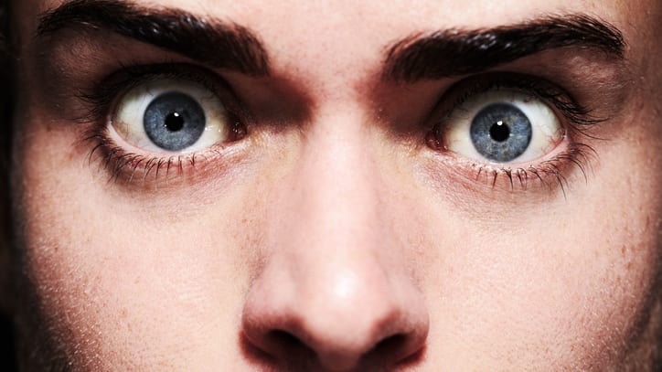 A close up of a man with blue eyes.