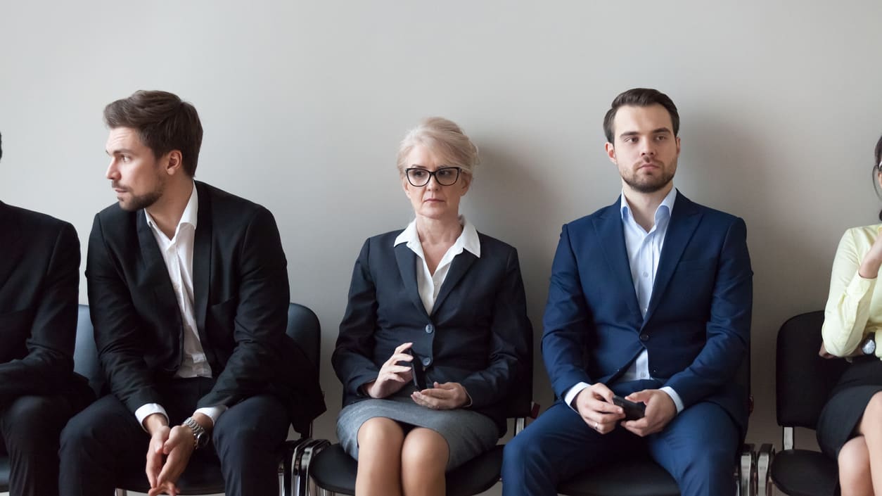 A group of business people sitting in a row.