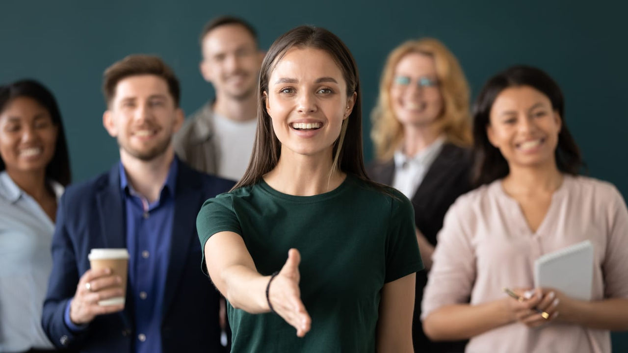 A group of business people standing in front of a blackboard.