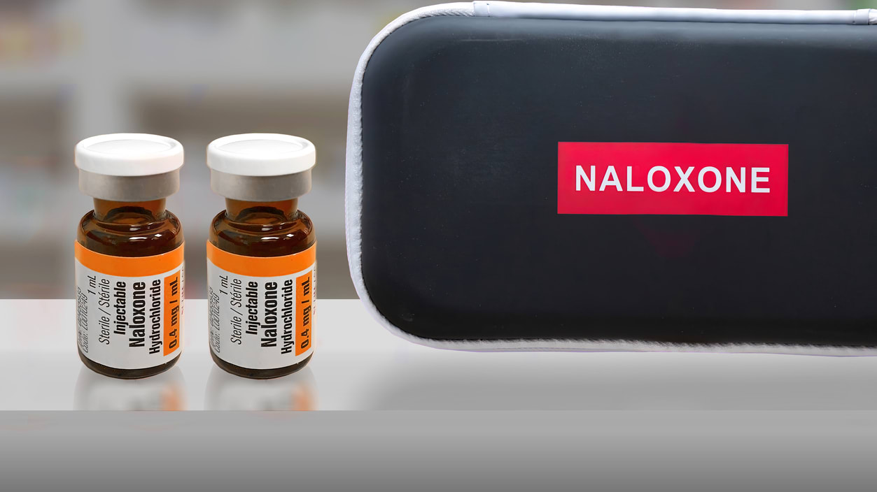 Two bottles of naloxyone on a table.