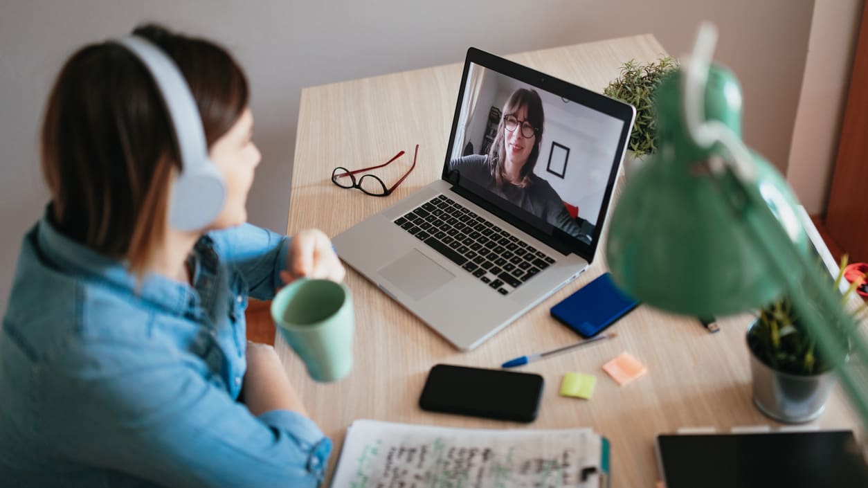 A woman is on a video call on her laptop.