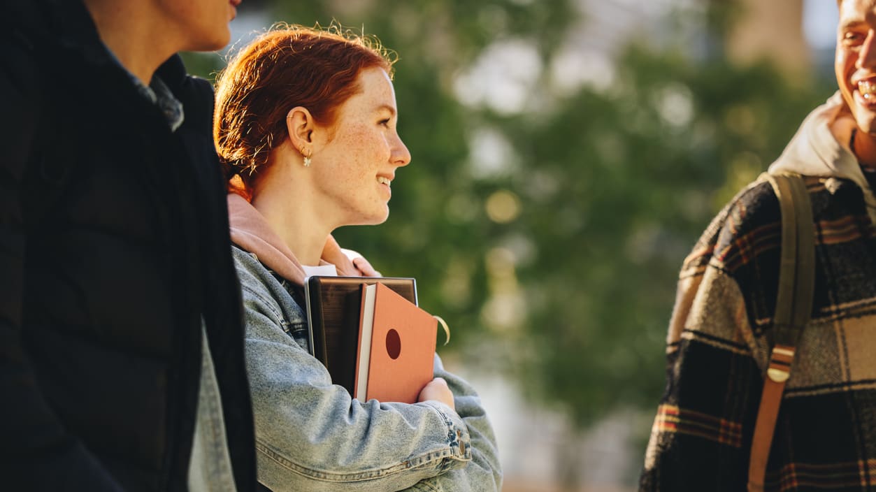 A group of college students are talking to each other.