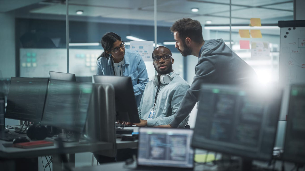 A group of people working on computers in an office.