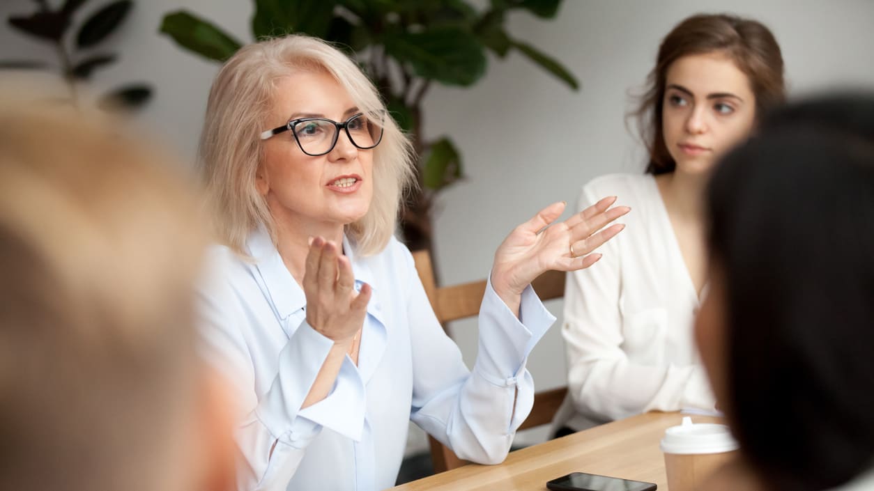 A group of women sitting at a meeting table.