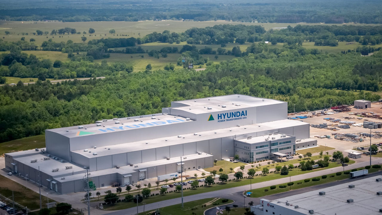 An aerial view of a factory in the middle of a forest.