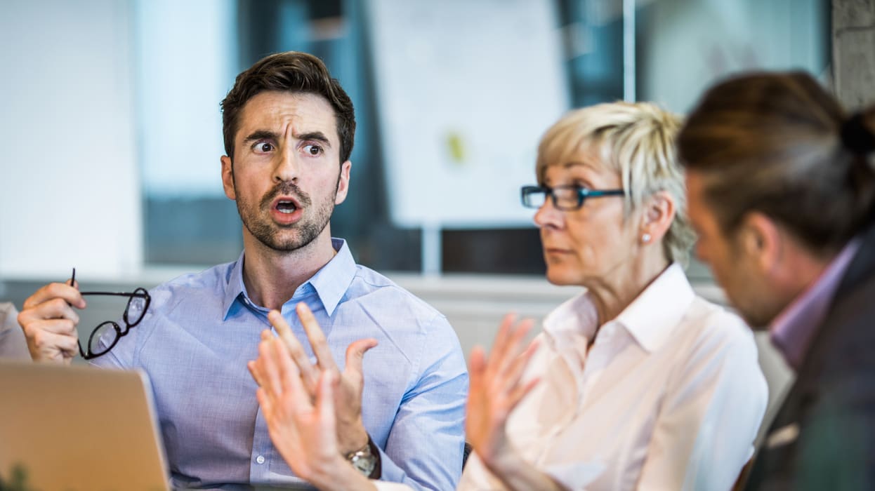 A group of business people are having a discussion in a meeting.