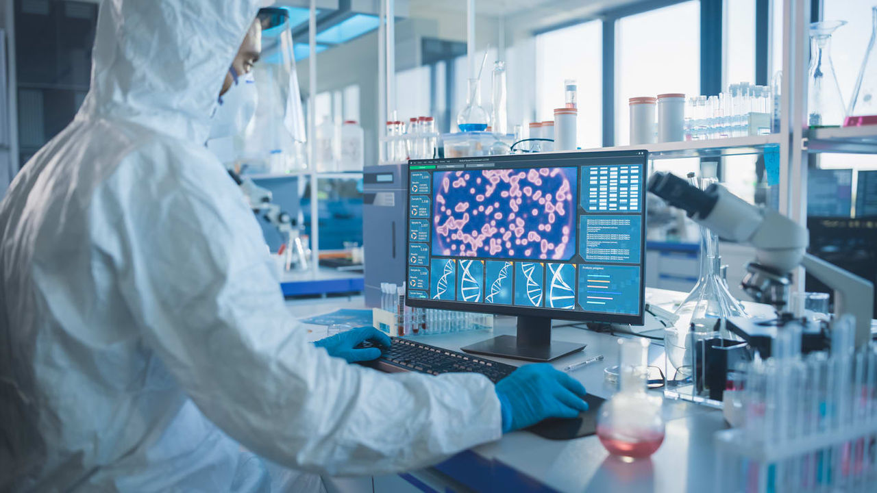 A scientist working on a computer in a laboratory.