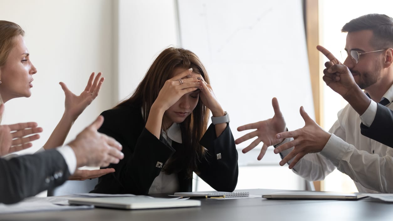 A group of business people arguing at a meeting.