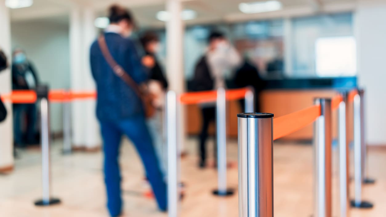 A group of people standing in a line at an airport.