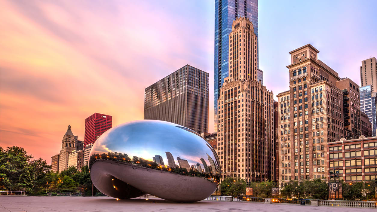 Downtown Chicago, illinois - Cloud Gate sculpture in front of skyscrapers.