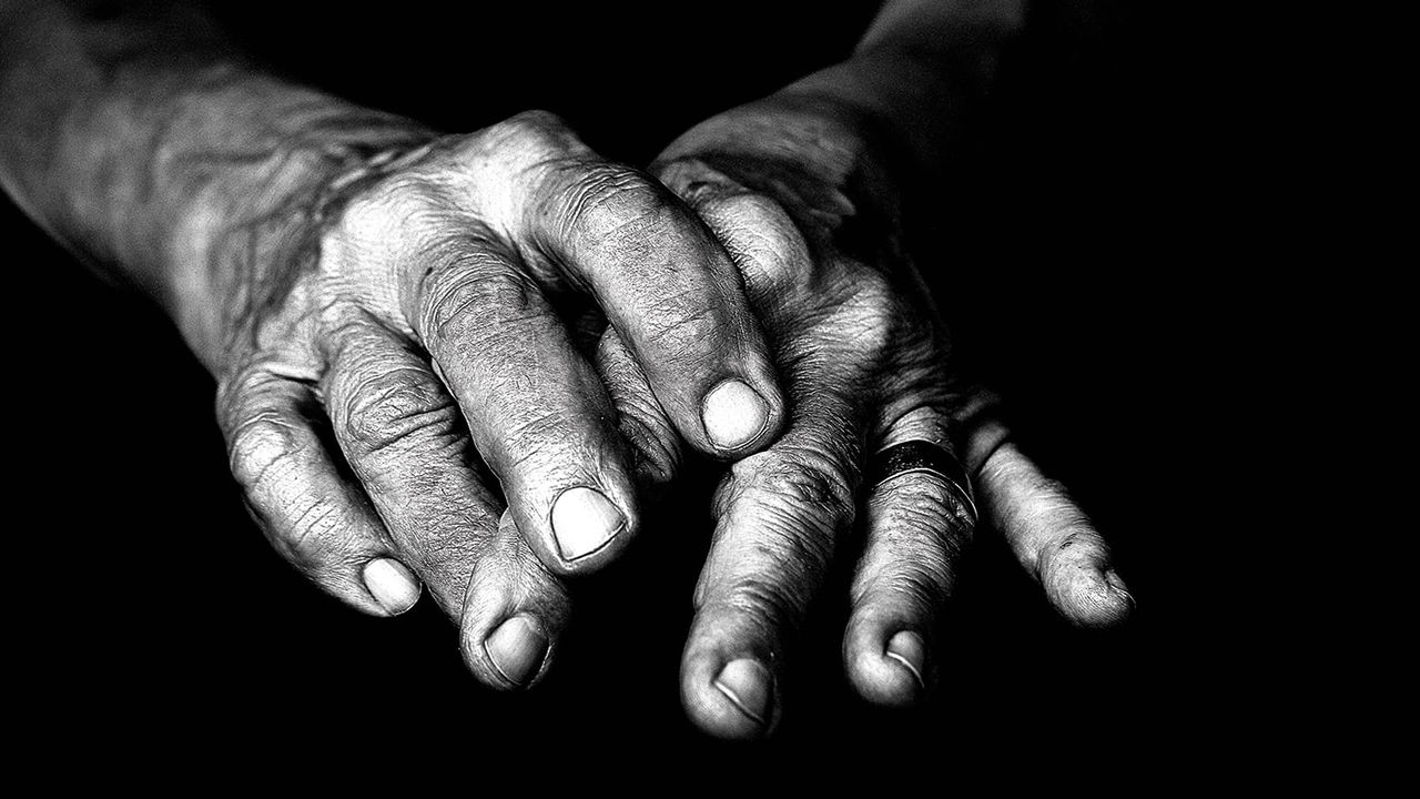 A black and white photo of an old woman's hands.