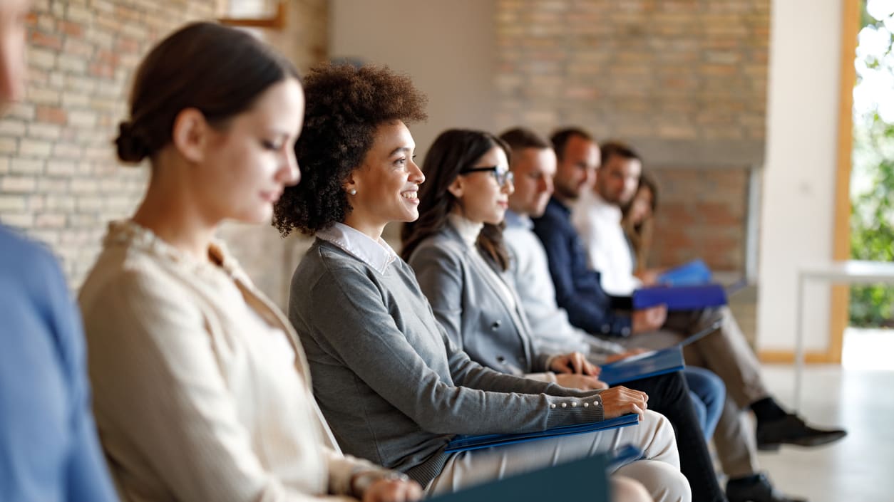 A group of business people sitting in a row.