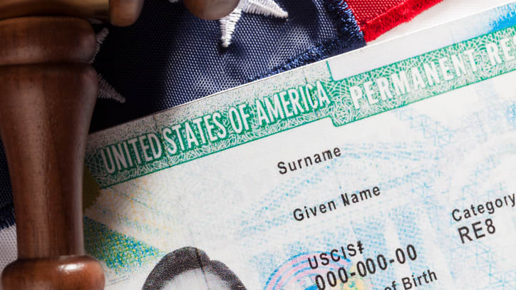 A gavel sits on top of a u s id card.