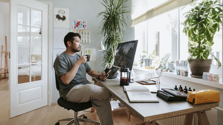 A man working at his desk in his home office.