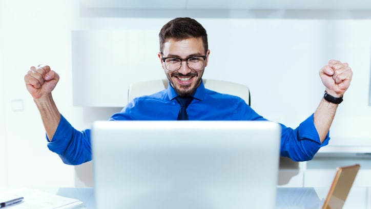 A man sitting in front of a laptop.