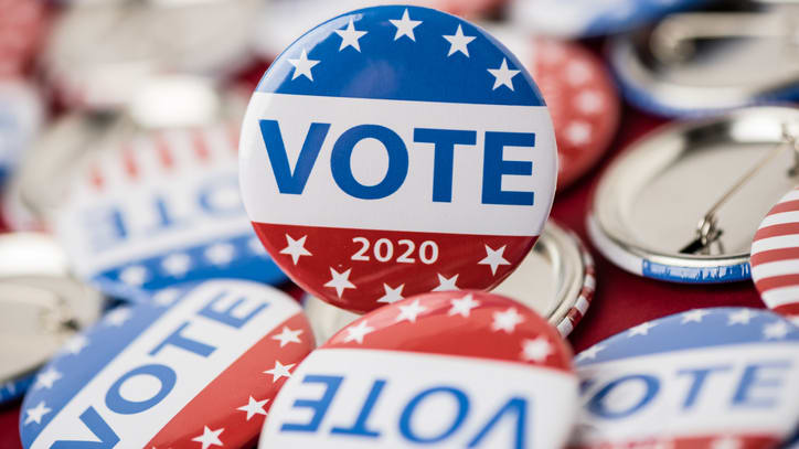 A group of buttons with the word vote on them.