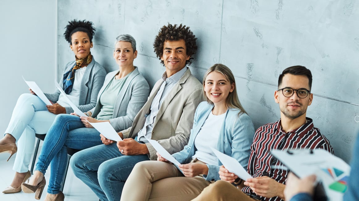 A group of people sitting in a waiting room.