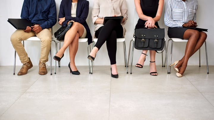 A group of business people sitting in a row.