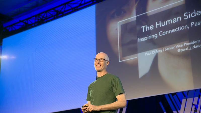 A man standing in front of a screen.