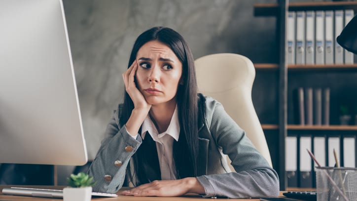 A woman sitting at a desk in front of a computer.