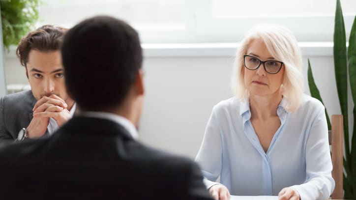 Two people sitting at a table in an interview.