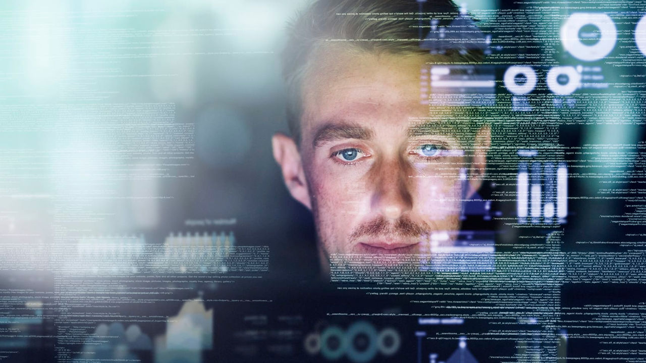 An image of a man looking at a computer screen.