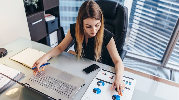 A business woman working on her laptop in an office.