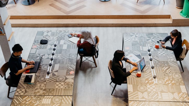 A group of people working at desks in an office.