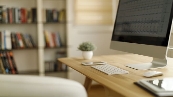 A computer is sitting on a desk in a home office.
