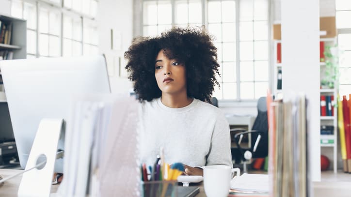 A woman sitting at a desk in an office.