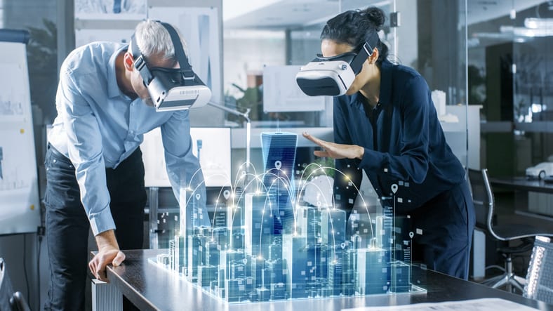 Two people wearing virtual reality glasses in an office.
