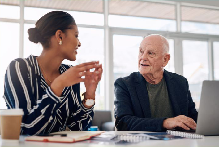 10-24-24-harmonizing-workplace-comm-norcal Young woman and older man having a discussion