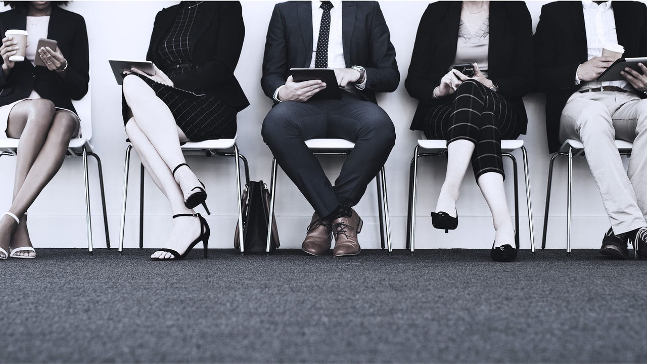 A group of business people sitting in a row.