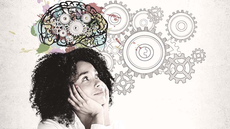 A woman looking at a brain with gears in the background.