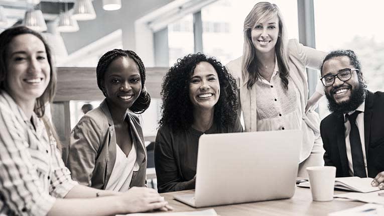 A group of business people sitting around a table.