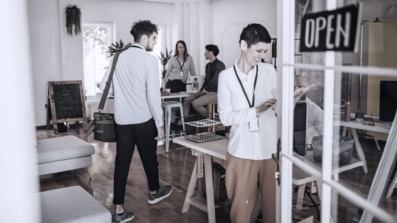 A group of people standing in an open office.