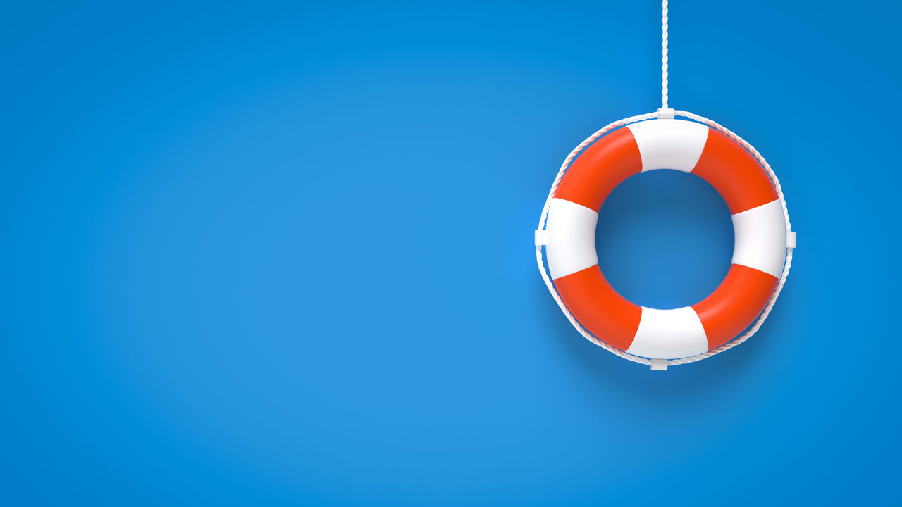 A life preserver hanging from a rope on a blue background.