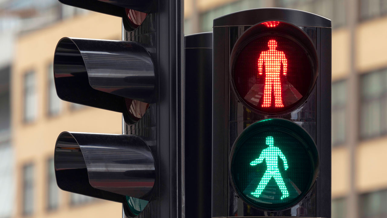 A traffic light with a man and a woman on it.