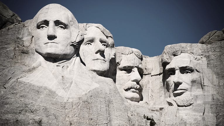 Presidents are carved into the rock face of mount rushmore.