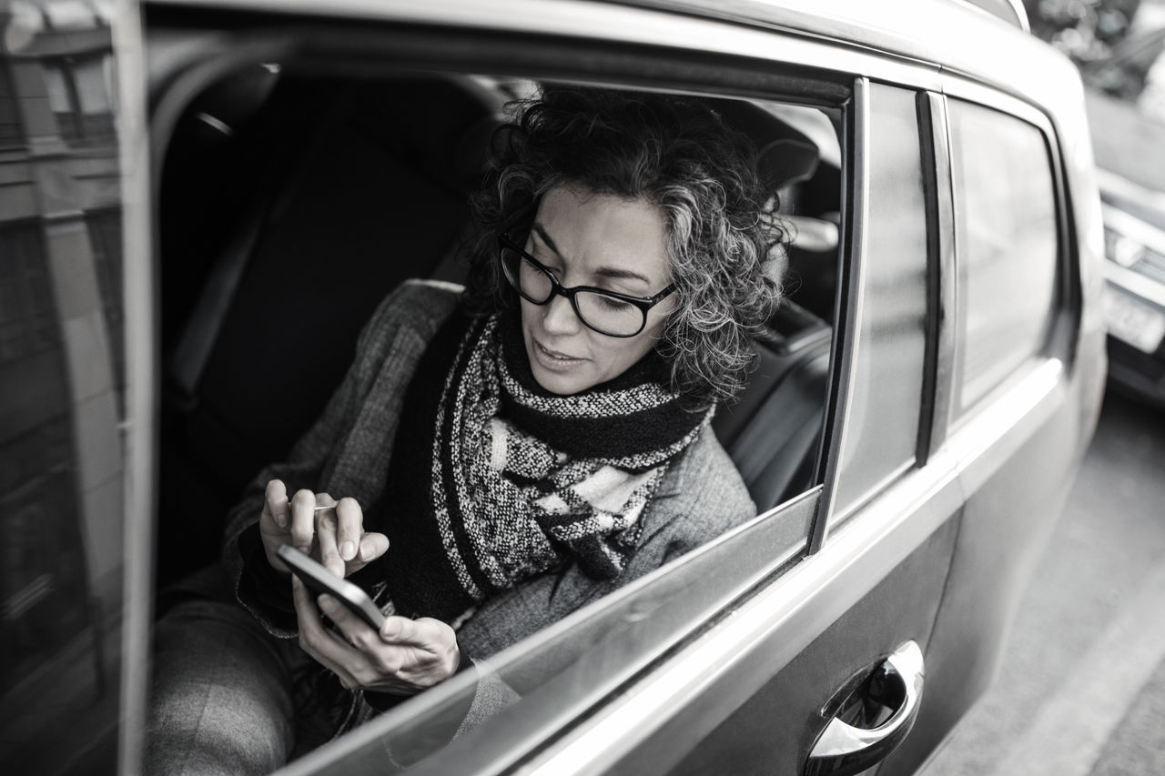 woman on phone inside a car