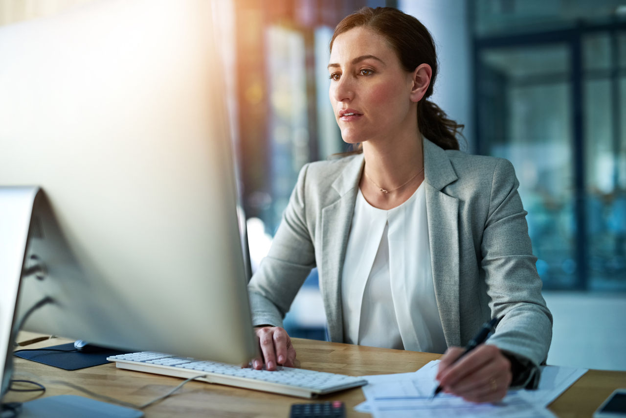 Shot of a businesswoman working behind her computer in the office.