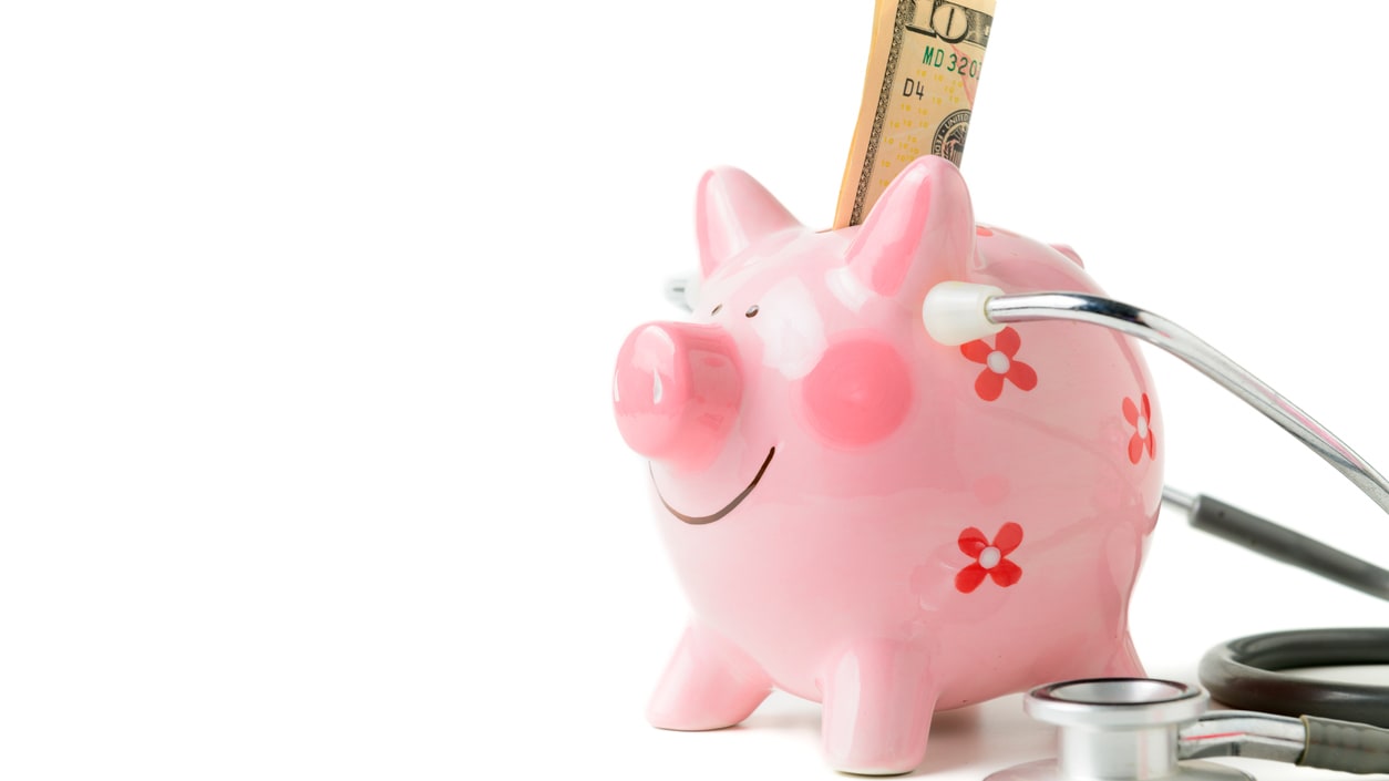 A piggy bank with a stethoscope and money.