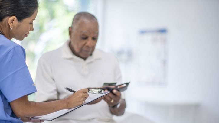 A nurse is talking to an elderly patient.