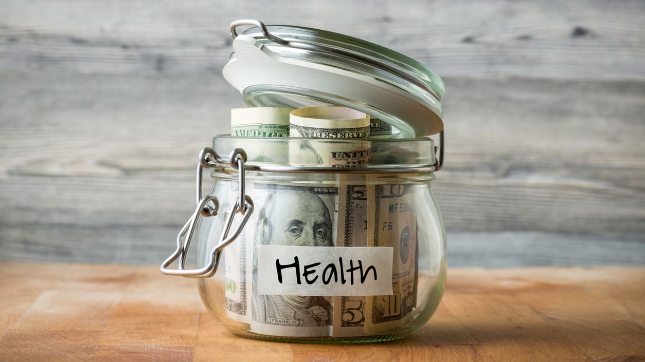 A jar of money with the word health on it.