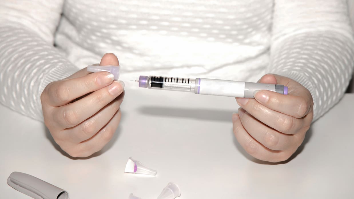 A person holding a syringe
