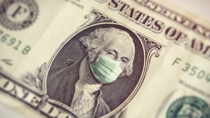 A dollar bill with a surgical mask on it.
