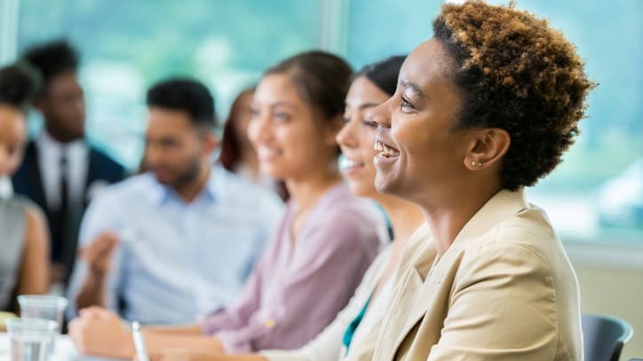 A group of business people sitting at a conference table.