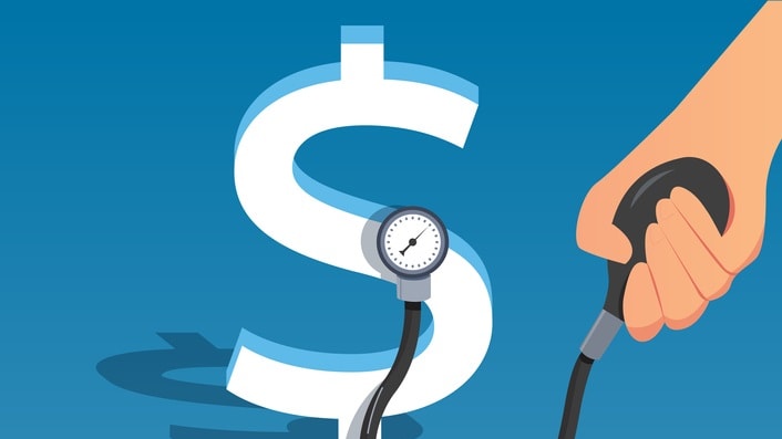 A hand holding a stethoscope next to a dollar sign.